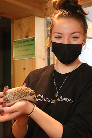 NV Specialized Careers Vet student holds animal. NV Specialized Careers Vet student holds animal.