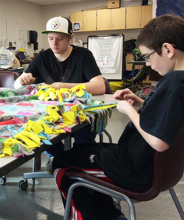 students work on tied blanket project students work on tied blanket project