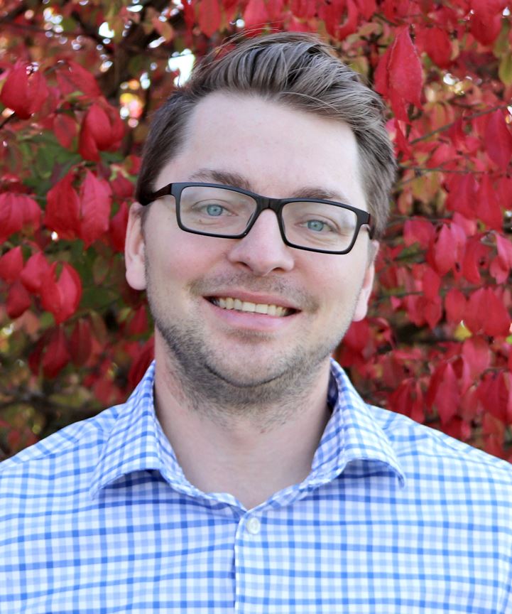Photo of Paul Griser in front of colorful tree