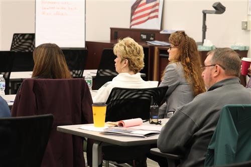 Oswego staff look on during presentation 